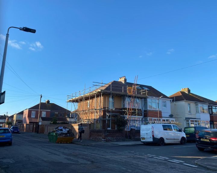 A roof being repaired with a scaffolding erected to allow roofers safe access.